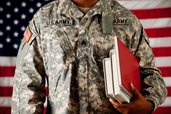 military vet holding school books in arm ready to learn