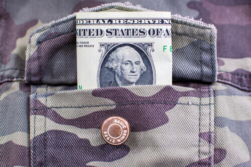 Military Servicemembers open shirt pocket filled with money