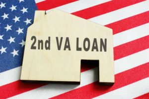 Keychain shaped like a house labeled 2nd VA Loan on top of an American flag