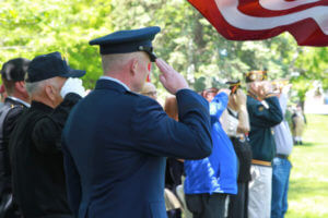 Retired veterans saluting the American Flag