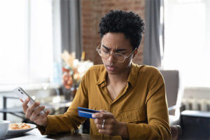 Woman receiving a fraud alert on her phone from a credit monitoring service