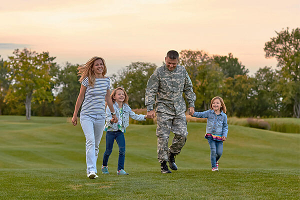 Military familiy walking through the park