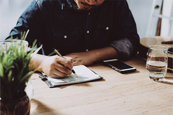 Military service member at home writing down a retirement plan