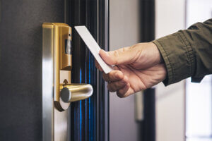 Military servicemember unlocking door to a discounted hotel room