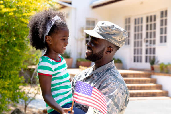 Military veteran holding his child