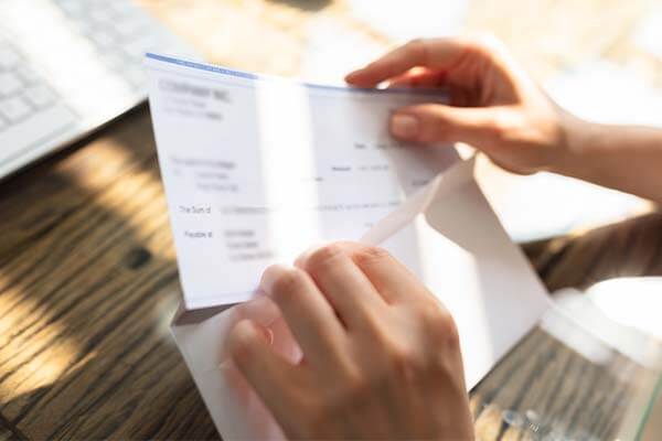 Opening an envelope with a paycheck for military special pay
