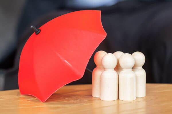 Red umbrella covering a group of figurines