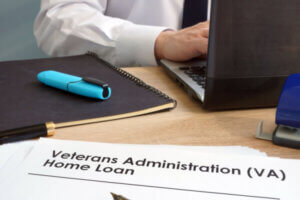 Lender with paperwork for the different types of va loans on his desk