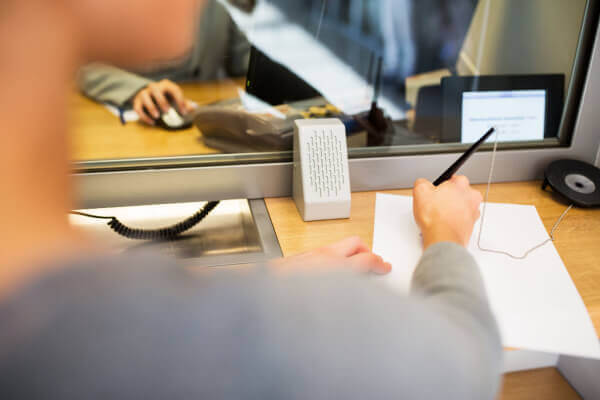 Bank teller filling out information for a military customer