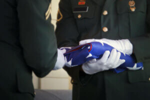 American soldier folding flag at veterans funeral