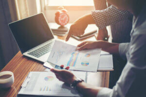 Military service member looking through financial charts on desk