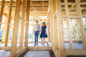 Military couple walking through their under construction house