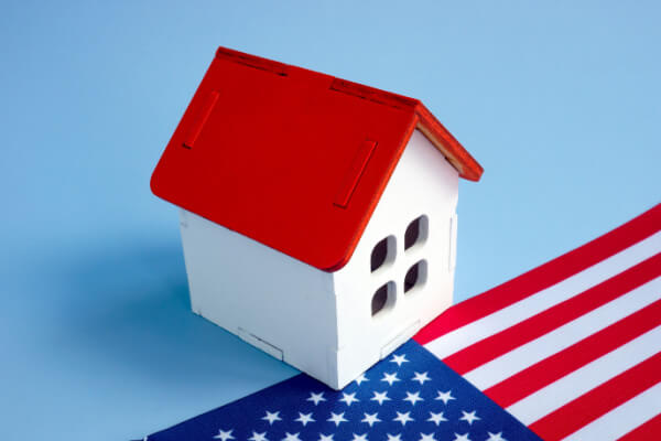 Replica of a home on top of an American flag